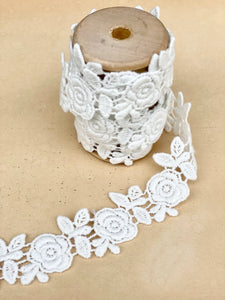 Rose garland lace on a wooden spool