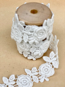 Rose garland lace on a wooden spool